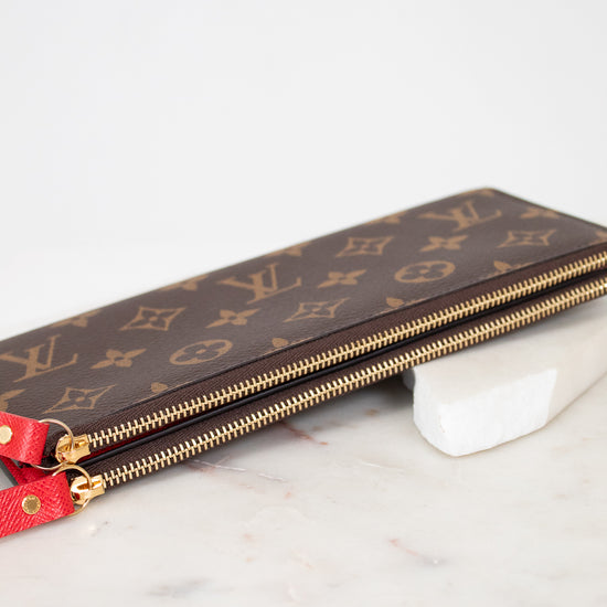 Louis Vuitton wallet with monogram pattern on a marble surface