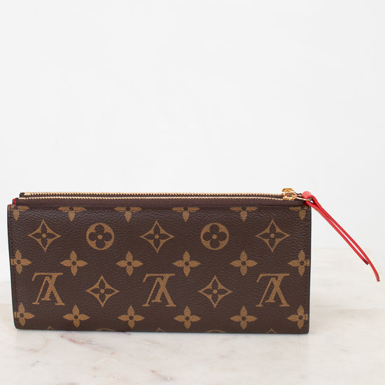 Louis Vuitton wallet with monogram pattern on a marble surface