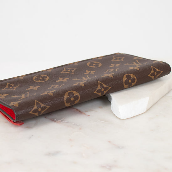 Louis Vuitton wallet with monogram pattern on a marble surface