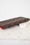 Louis Vuitton wallet with monogram pattern on a marble surface