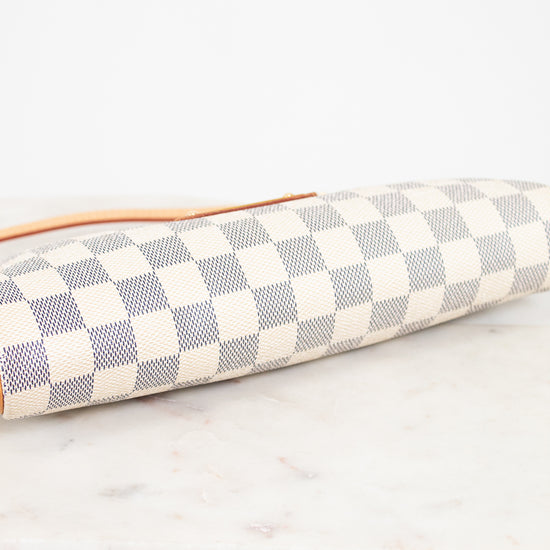 Checkered clutch bag on a marble surface