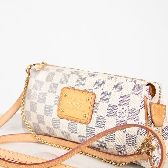 Checkered handbag with gold accents on a white background