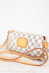 Checkered handbag with gold accents on a white background