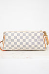 Checkered handbag with gold accents on a white background