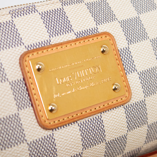 Louis Vuitton wallet with checkered pattern and gold plaque on a light gray background