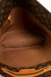 Close-up of a brown leather bag with visible brand logo pattern.