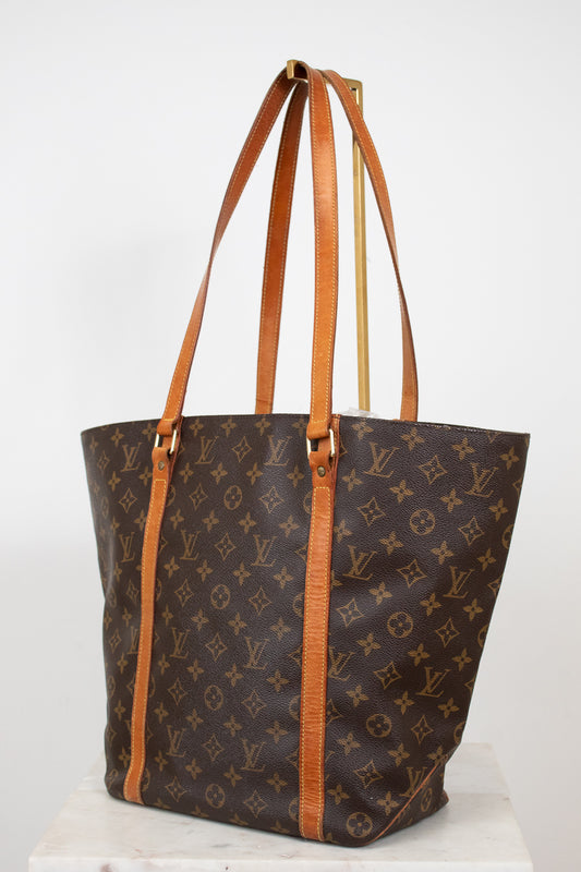 Designer handbag with monogram pattern on a white background