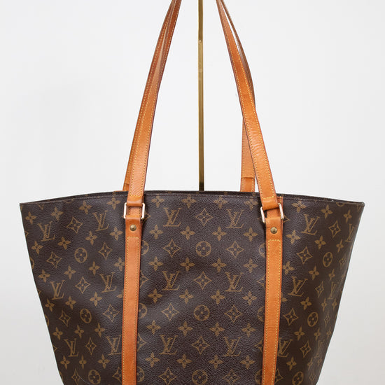 Designer handbag with monogram pattern on a white background