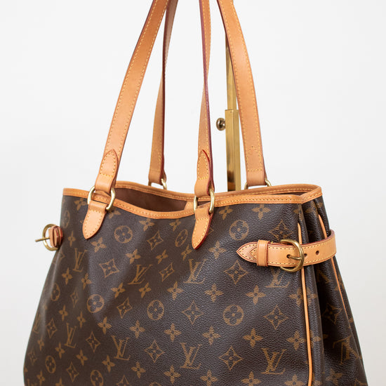 Designer handbag with monogram pattern on a white background