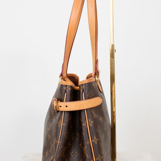 Brown monogram handbag with tan handles on a white background