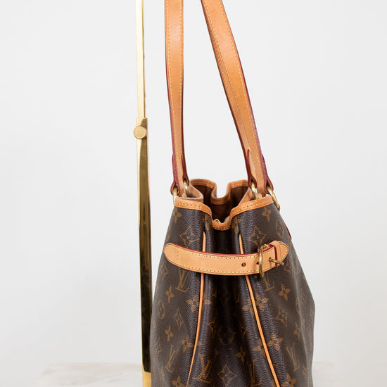 Designer handbag with monogram pattern on a white background