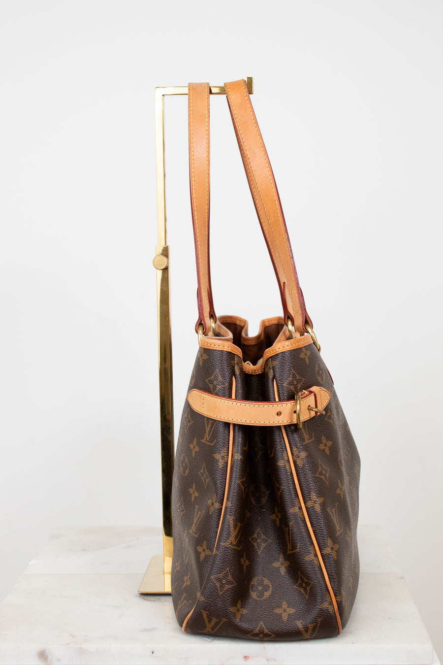 Designer handbag with monogram pattern on a white background