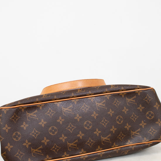 Designer handbag with monogram pattern on a white background