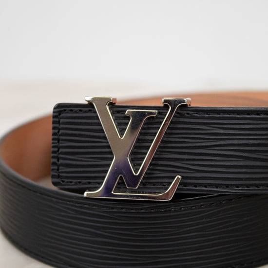 Black belt with a silver buckle on a light background