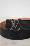 Black belt with a silver buckle on a light background