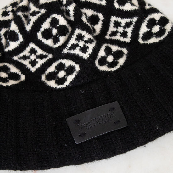 Black beanie with white pattern on a marble surface