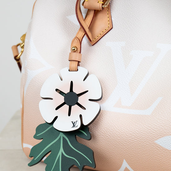 Floral design luggage tag on a handbag with a white background