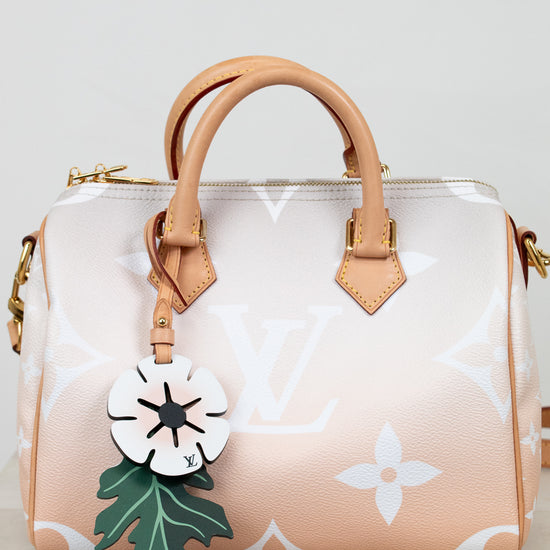 Handbag with a floral keychain on a light background