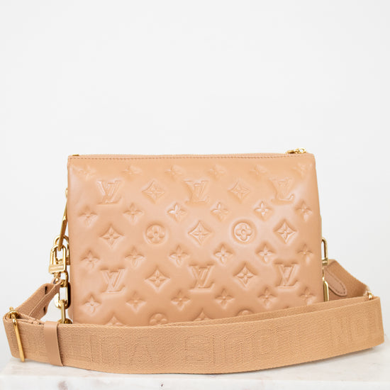 Beige handbag with brand logo on a white background