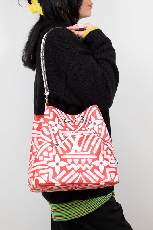 Person wearing a red and white patterned bag on a plain background
