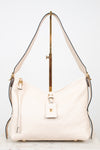 A cream-colored Louis Vuitton shoulder bag with gold-tone hardware and a matching leather hangtag, displayed on a stand against a white background.