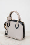 White handbag with black accents on a white background
