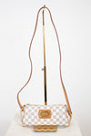 A Louis Vuitton shoulder bag in Damier Azur canvas with a brown leather strap and gold-tone hardware, displayed on a stand against a white background.