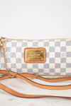 A Louis Vuitton shoulder bag in the Damier Azur coated canvas, featuring a blue and white checkered pattern, tan leather trim, a gold-tone metal plaque, and a gold chain strap, displayed on a light marble surface against a white background.