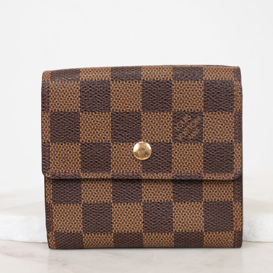 Brown checkered wallet with gold snap button on a white background