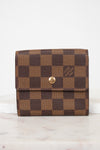 Brown checkered wallet with gold snap button on a white background