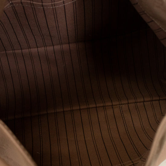 Close-up of a beige leather bag with visible stitching