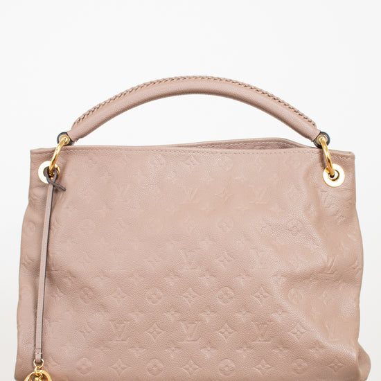 Beige handbag with gold accents on a white background
