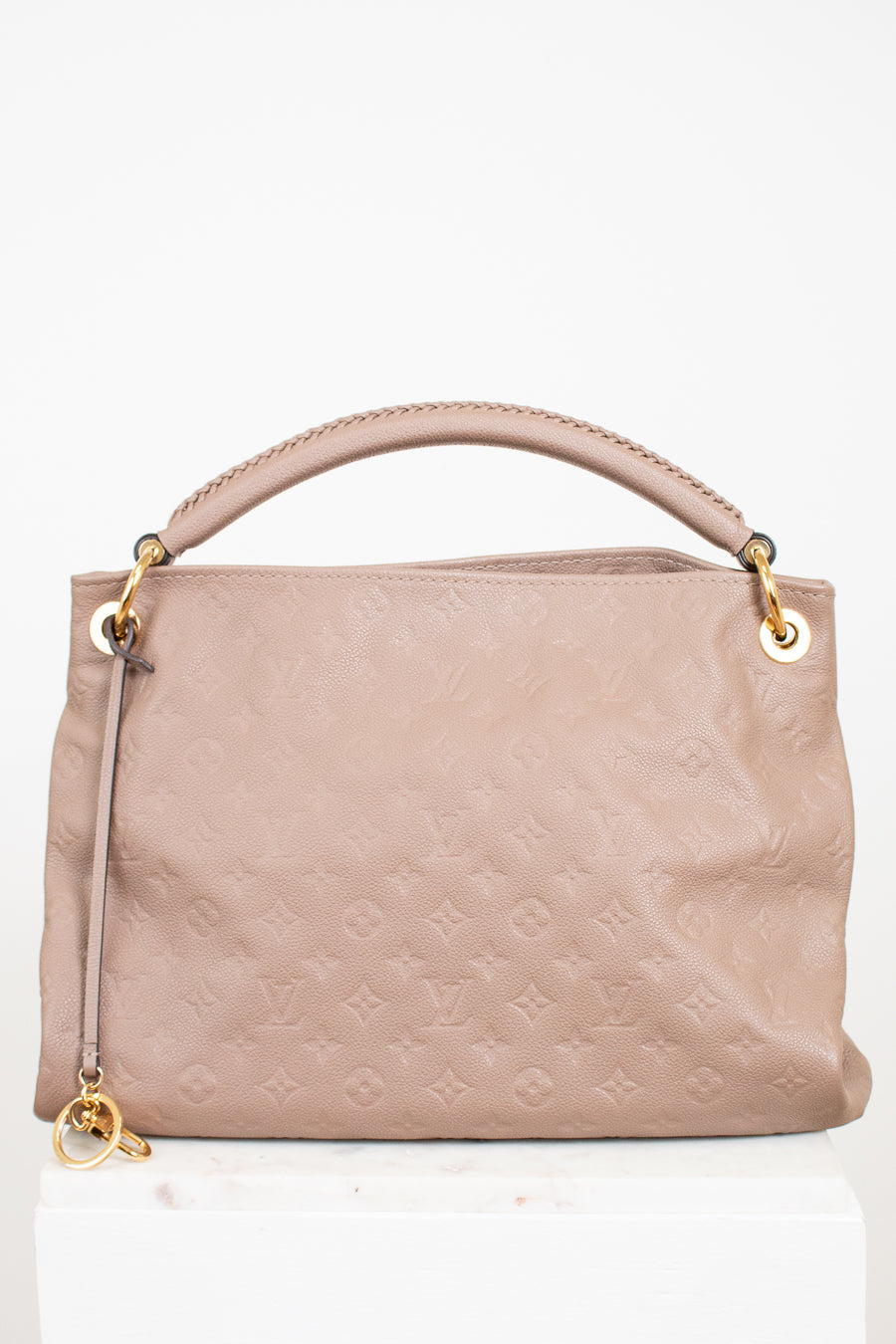 Beige handbag with gold accents on a white background