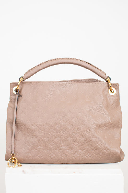 Beige handbag with gold accents on a white background