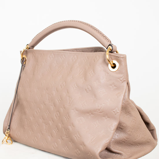 Beige handbag with gold accents on a white background