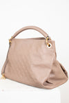 Beige handbag with gold accents on a white background