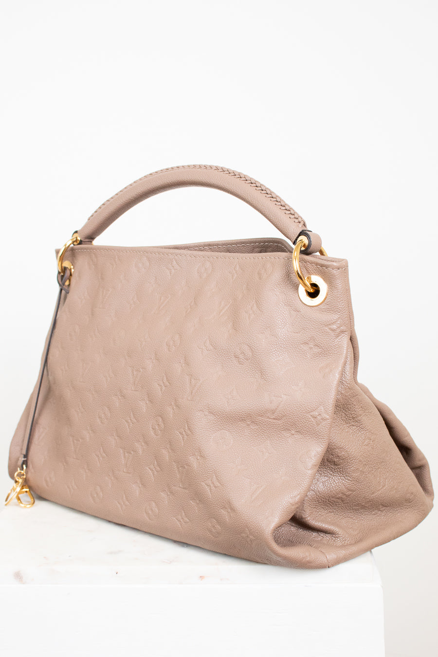 Beige handbag with gold accents on a white background