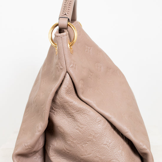 Beige handbag with a gold ring on a white background
