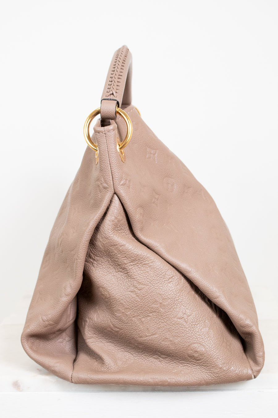 Beige handbag with a gold ring on a white background