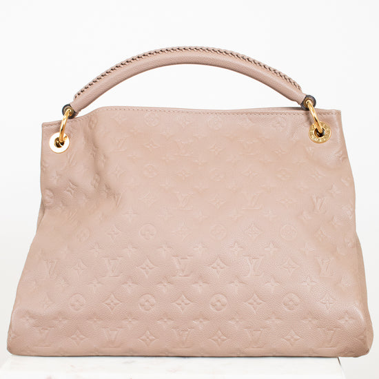Taupe handbag with gold accents on a white background