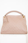 Taupe handbag with gold accents on a white background