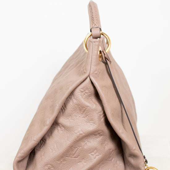 Beige handbag with gold hardware on a white background