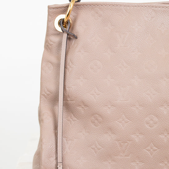 Beige handbag with gold hardware on a white background