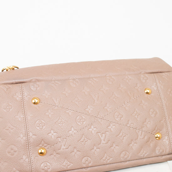 Beige handbag with gold hardware on a white background