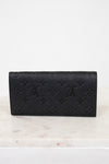 Black embossed wallet on a white marble surface