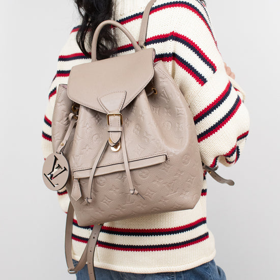 Person wearing a beige backpack with a white background