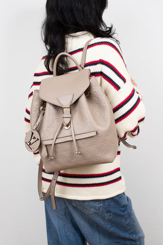 Person wearing a beige backpack with a white background