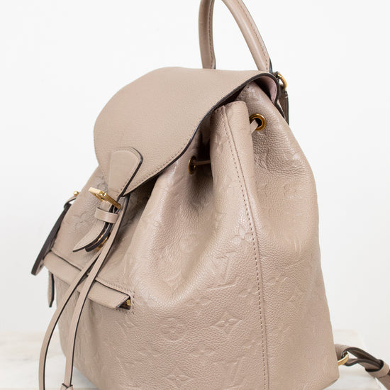 Beige backpack with a subtle logo pattern on a white background
