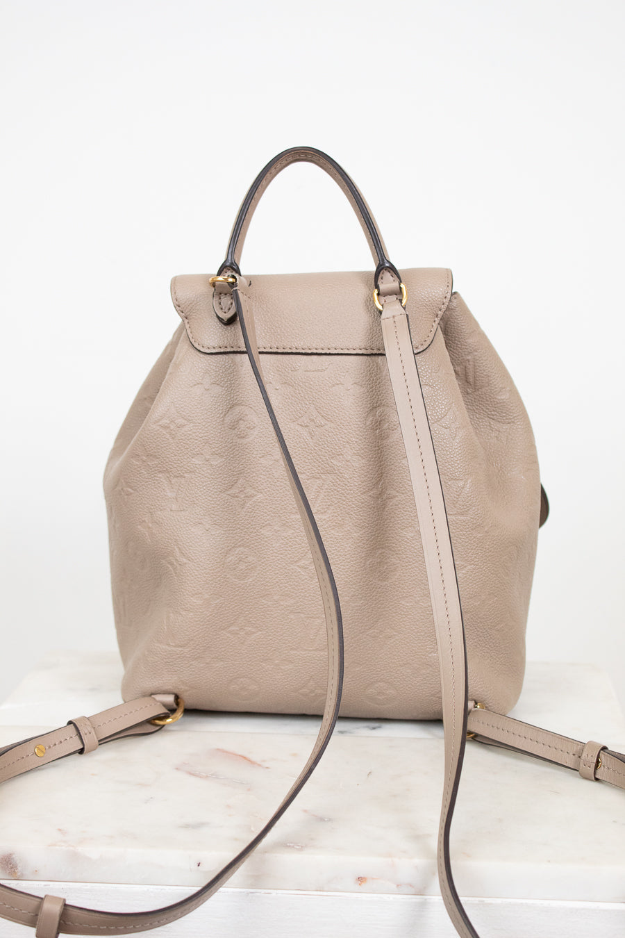 Beige backpack with a strap on a white background