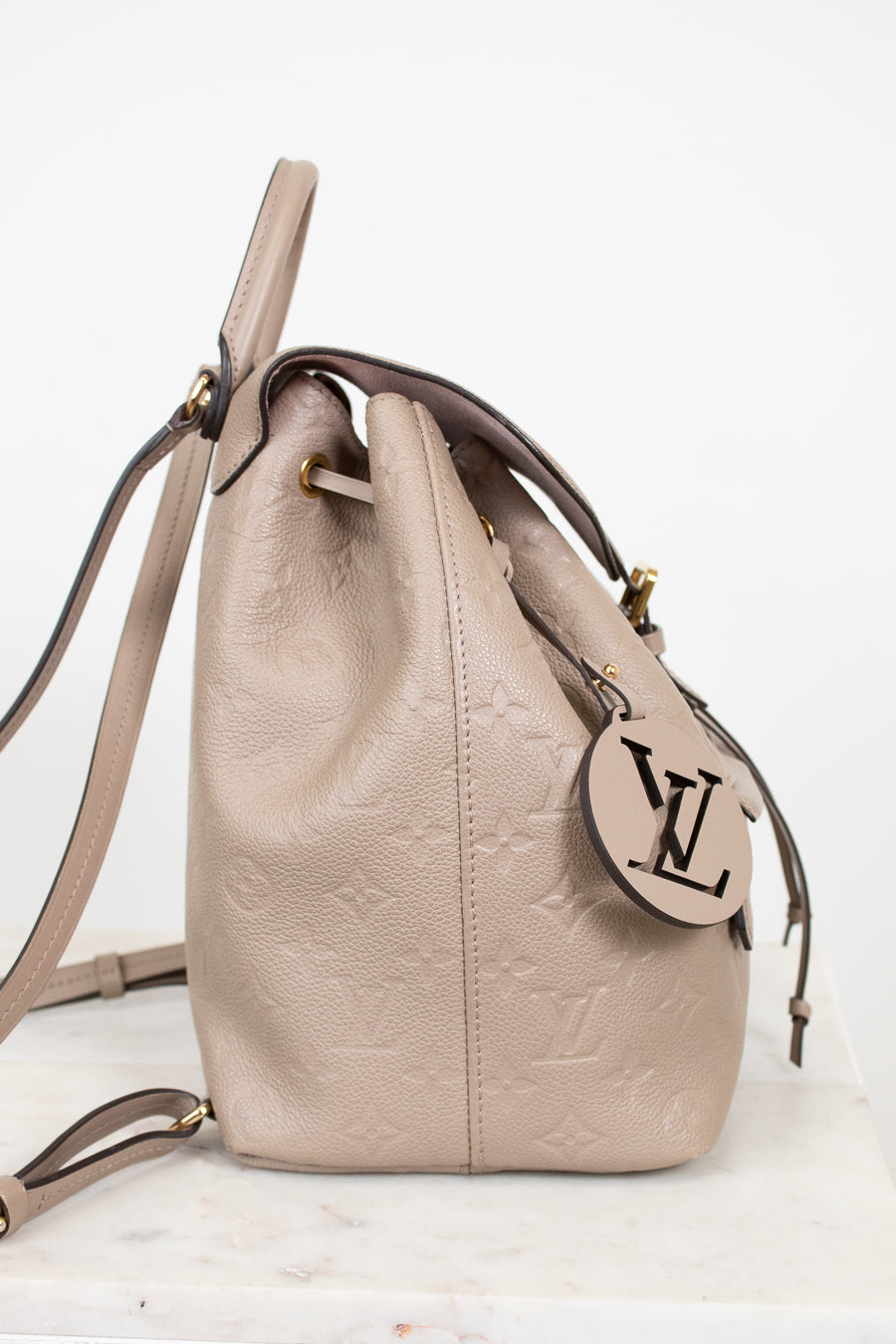 Beige handbag with a brand logo on a white background